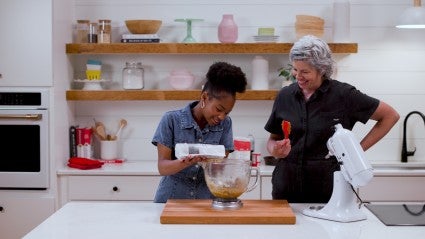 Kid and adult making cookies together